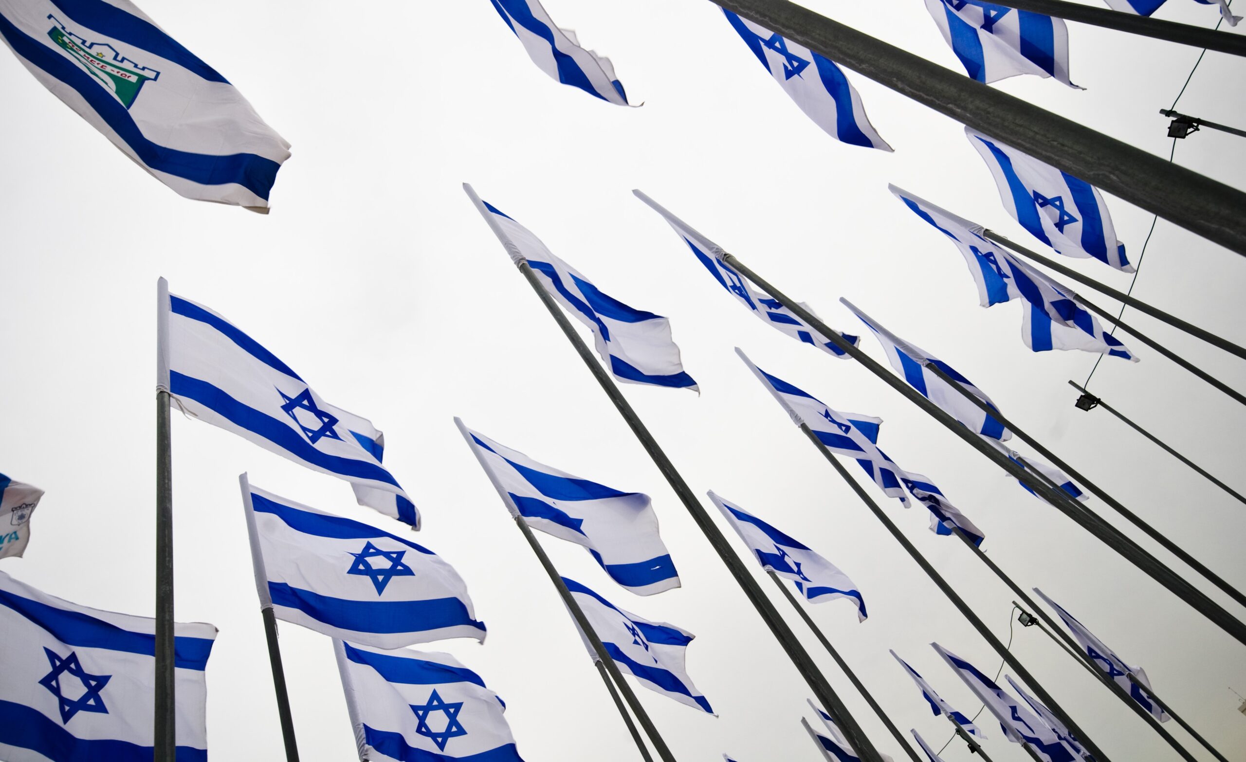 Israeli flags flutter in the wind in celebration of the country's 65th anniversary. (Shutterstock.com)