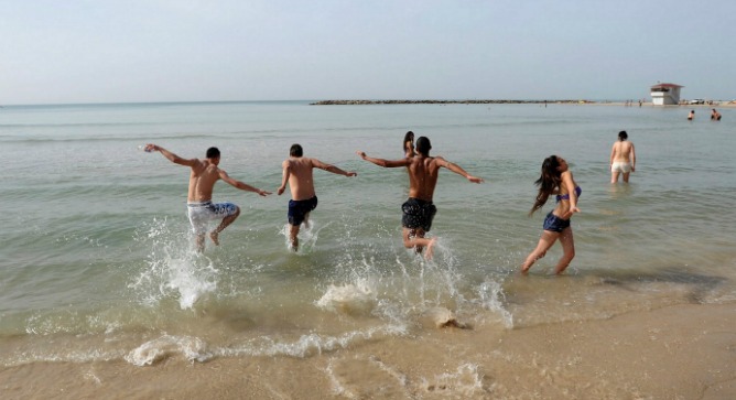 Enjoying the surf at Sironit Beach in Netanya. Photo by Flash90.