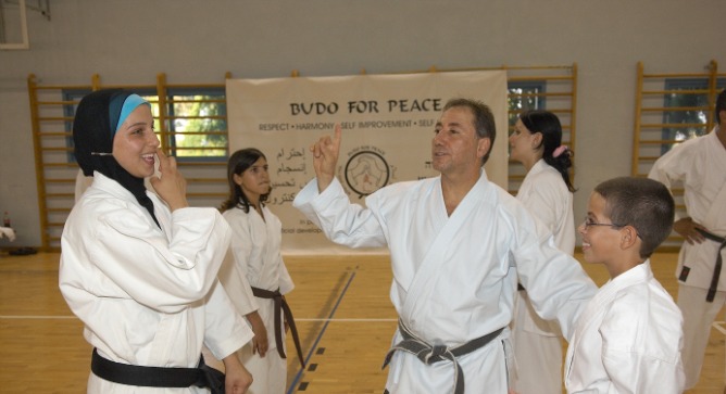 Peace with a kick to it. Danny Hakim with students at Budo for Peace.