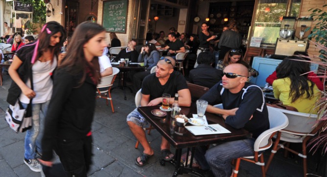 People watching on Tel Aviv’s most famous street. Image via ChameleonsEye / Shutterstock.com.