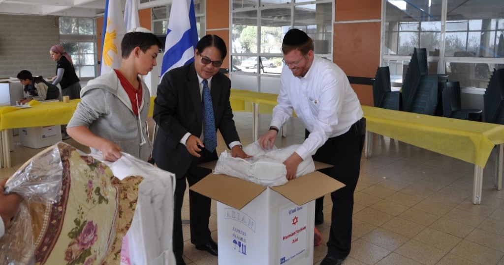 Philippine Ambassador to Israel Generoso D. G. Calonge joined Israeli youth at the Boys Town Jerusalem school to pack aid for his typhoon stricken country. (Courtesy)