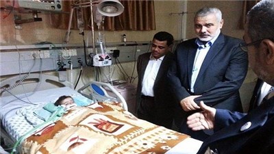 Ismail Haniyeh visits his granddaughter in a Gazan hospital. (Social media networks)