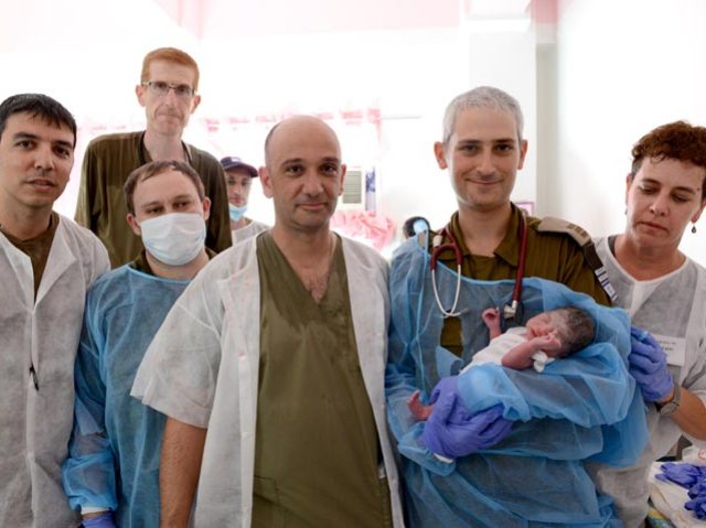 Israeli doctors with first Philippine baby born in field hospital. (IDF Spokesperson)