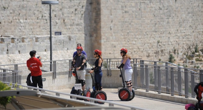Tourists pause for a photograph as they ride through the Old City of Jerusalem. Photo by Flash90.