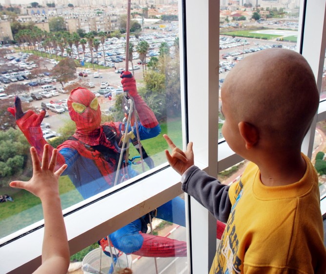 Spiderman swoops in to Schneider Children's Medical Center to say Happy Purim to young patients. (Courtesy of Schneider Children's Medical Center)
