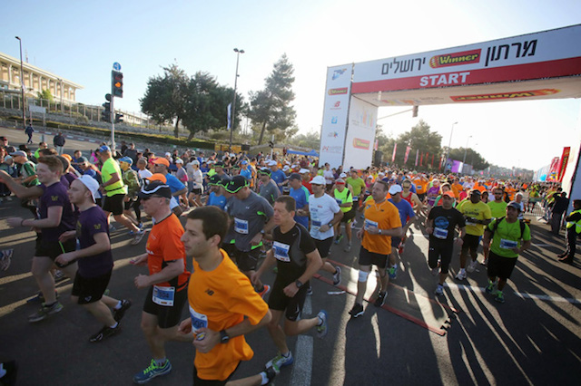 Runners take in Jerusalem's sights during the Marathon in 2014.
