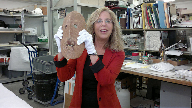 Debby Hershman in her museum lab with one of the ancient masks. Photo by Abigail Klein Leichman