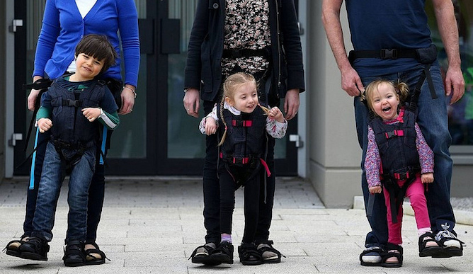 Daniel Smyth, 5, Bethany Watson, 3, and Charlotte Taylor, 3, using a Firefly Upsee to walk with their parent. Photo courtesy of Leckey Firefly