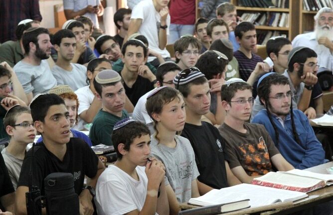 Students of the Mekor Chaim yeshiva in Kibbutz Kfar Etzion, where two of the three kidnapped boys were students, listening to Israeli Minister of Economics Naftali Bennett addressing them on June 16, 2014. (Photo by Gershon Elinson/FLASH90)