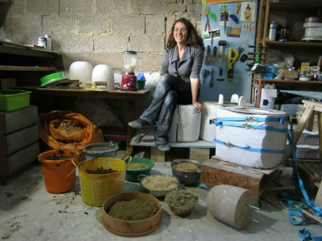 Adital Ela surrounded by natural materials in her studio.
