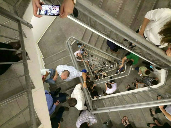 Employees at the Azrieli Center in Tel Aviv go to the stairs to take shelter.