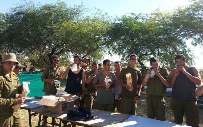 Soldiers enjoying their free sandwiches.