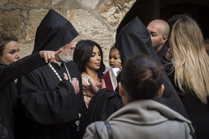 Reality-television star Kim Kardashian, holds her daughter North, as she is greeted by priests at the Saint James Armenian Church in the Armenian Quarter in Jerusalem's Old City. (Photo by Hadas Parush/Flash90)