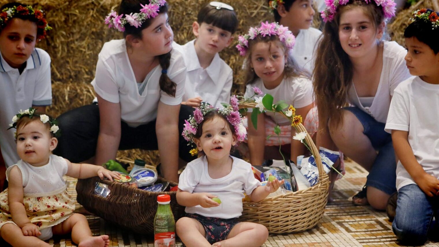 Children of dairy farmers celebrate Shavuot in Jerusalem with crowns of flowers on their heads. Photo by Miriam Alster/Flash90