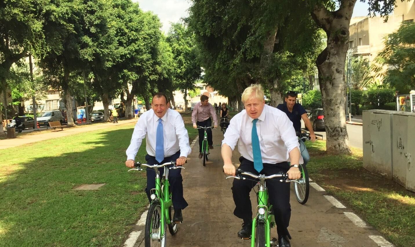 Mayors Johnson, right, and Huldai cycling around Tel Aviv on Tel-O-Fun bikes. Photo via Facebook