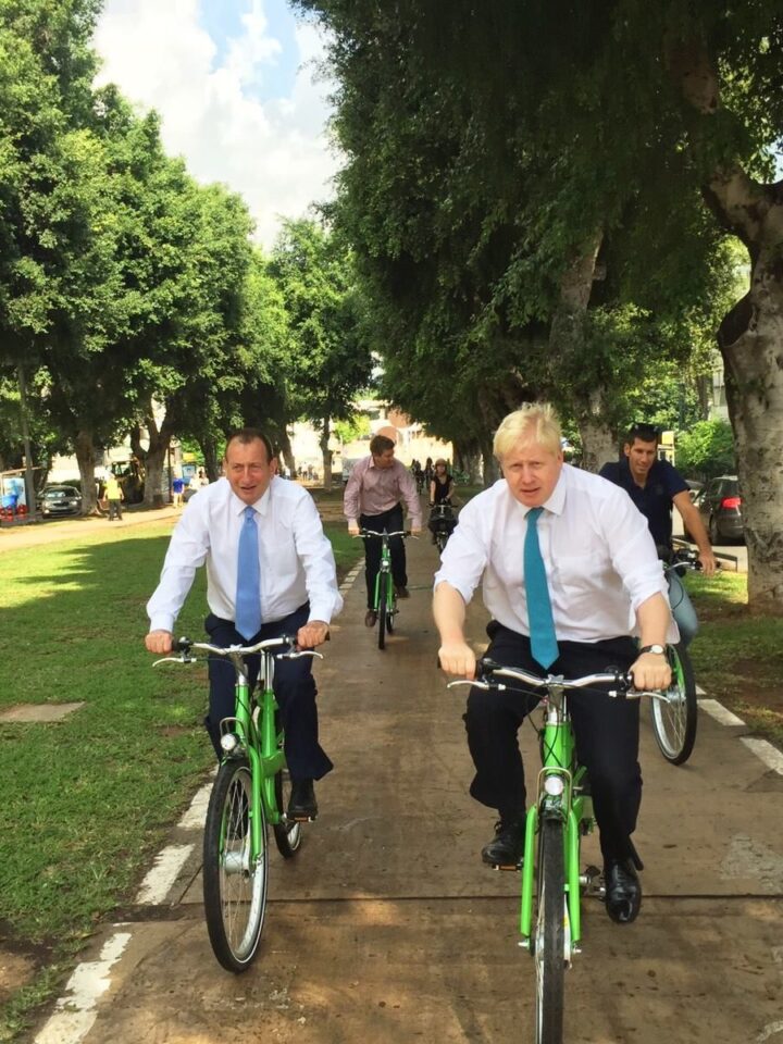 Mayors Johnson, right, and Huldai cycling around Tel Aviv on Tel-O-Fun bikes. Photo via Facebook