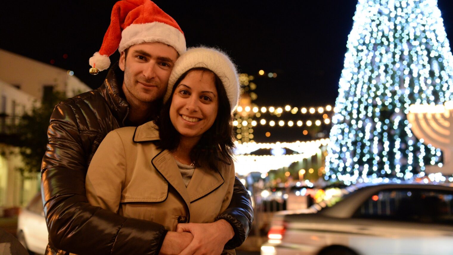 A couple gets into the Christmas spirit in the German Colony district of the northern Israeli city of Haifa. Photo by Sapir BronzbergFLASH90