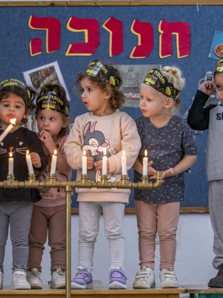 Children light Hanukkah candles at a kindergarden in Moshav Yashresh, on November 25, 2021. Photo by Yossi Aloni/Flash90