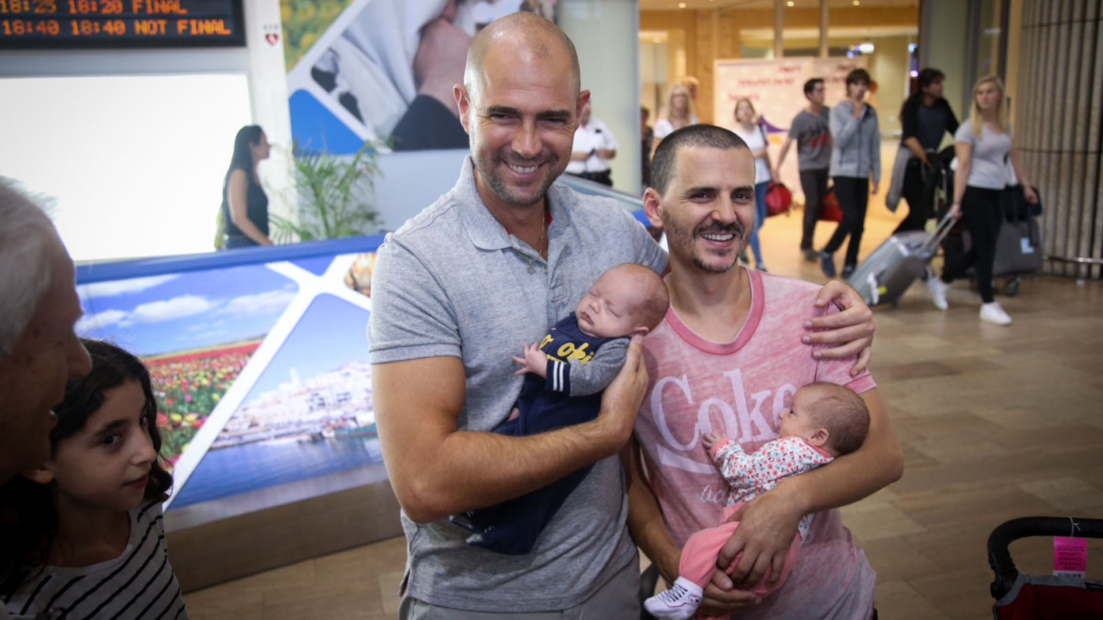 Likud MK Amir Ohana and his partner, Alon Hadad, seen at Ben-Gurion International Airport as they arrive back from the US with their children.  Photo by FLASH90