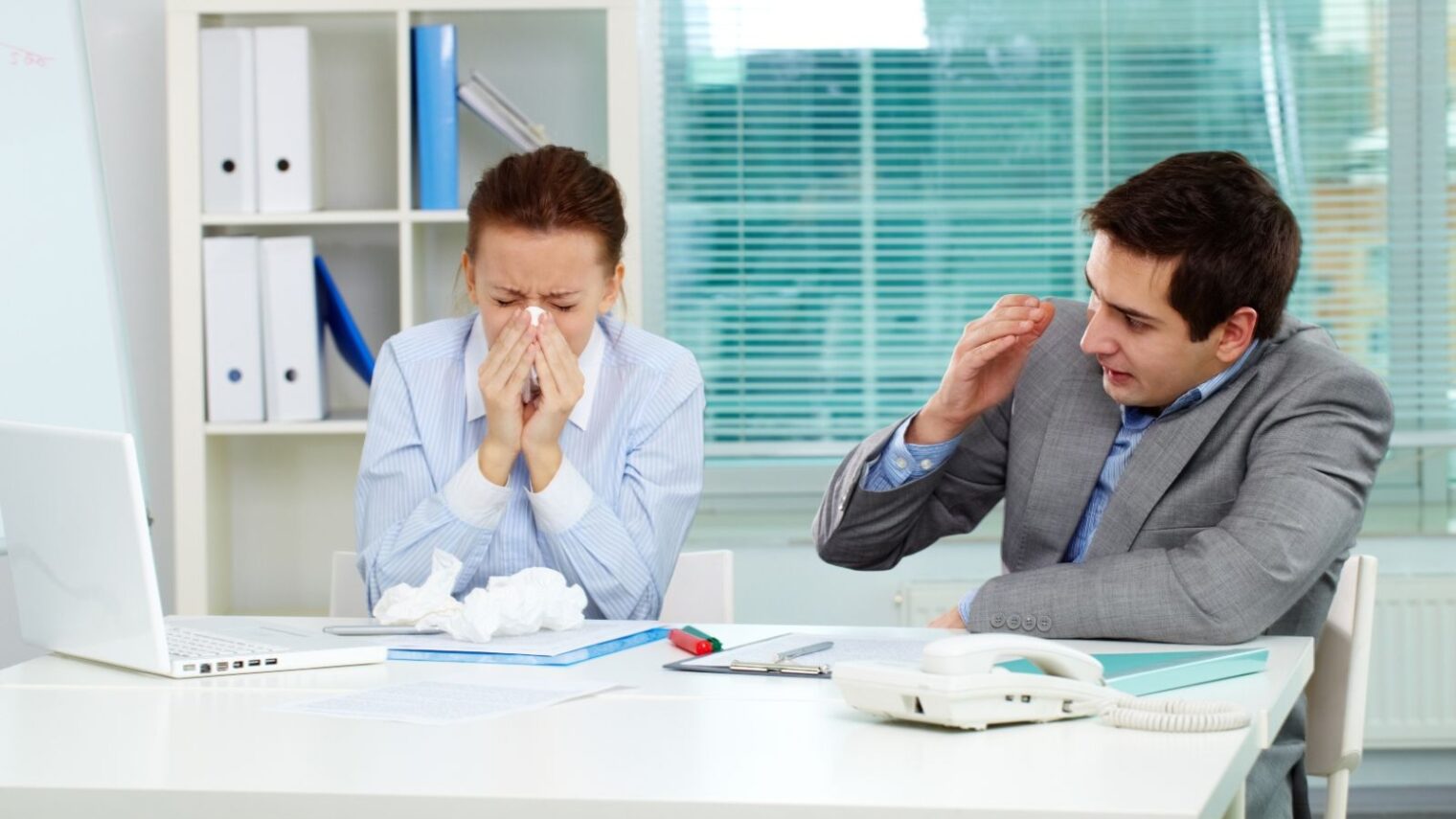 Feeling sick at work? Take a hint from your body and go home. Image via Shutterstock.com