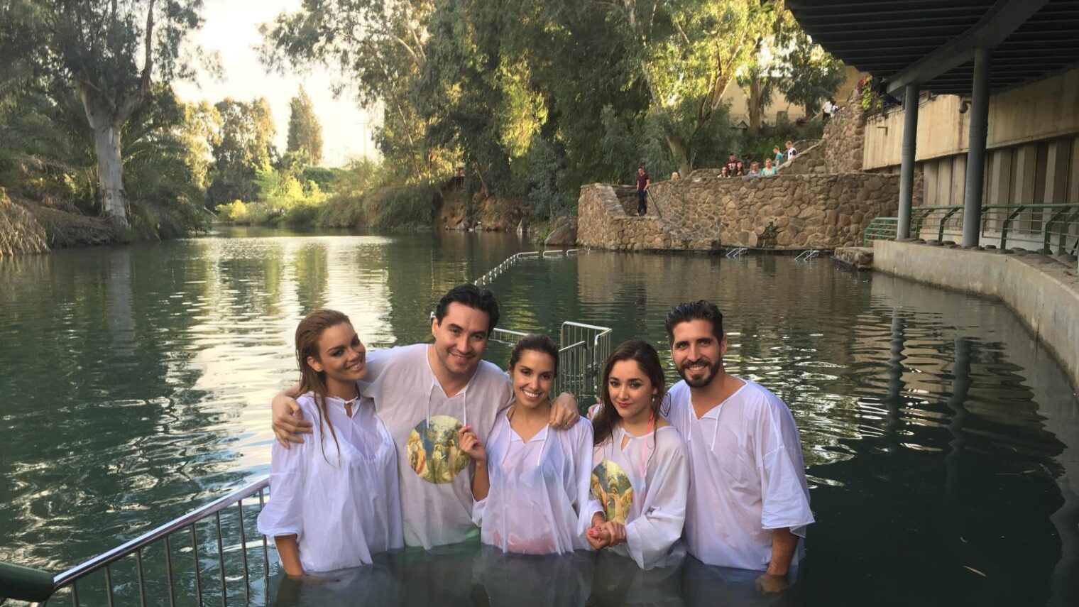 Being baptized in the Jordan River are, from left, Zuleyka Rivera, Luis Alfonso Borrego, Andrea Escalona, Sherlyn González, and Carlitos Perez-Ruiz (Luis Fonsi’s manager). Photo courtesy of America's Voices in Israel
