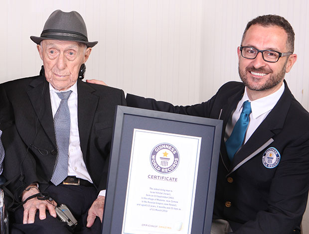 Guinness World Records’ Head of Records Marco Frigatti presents Israel Kristal with an official certificate as the world’s oldest living man. Photo by Guinness World Records