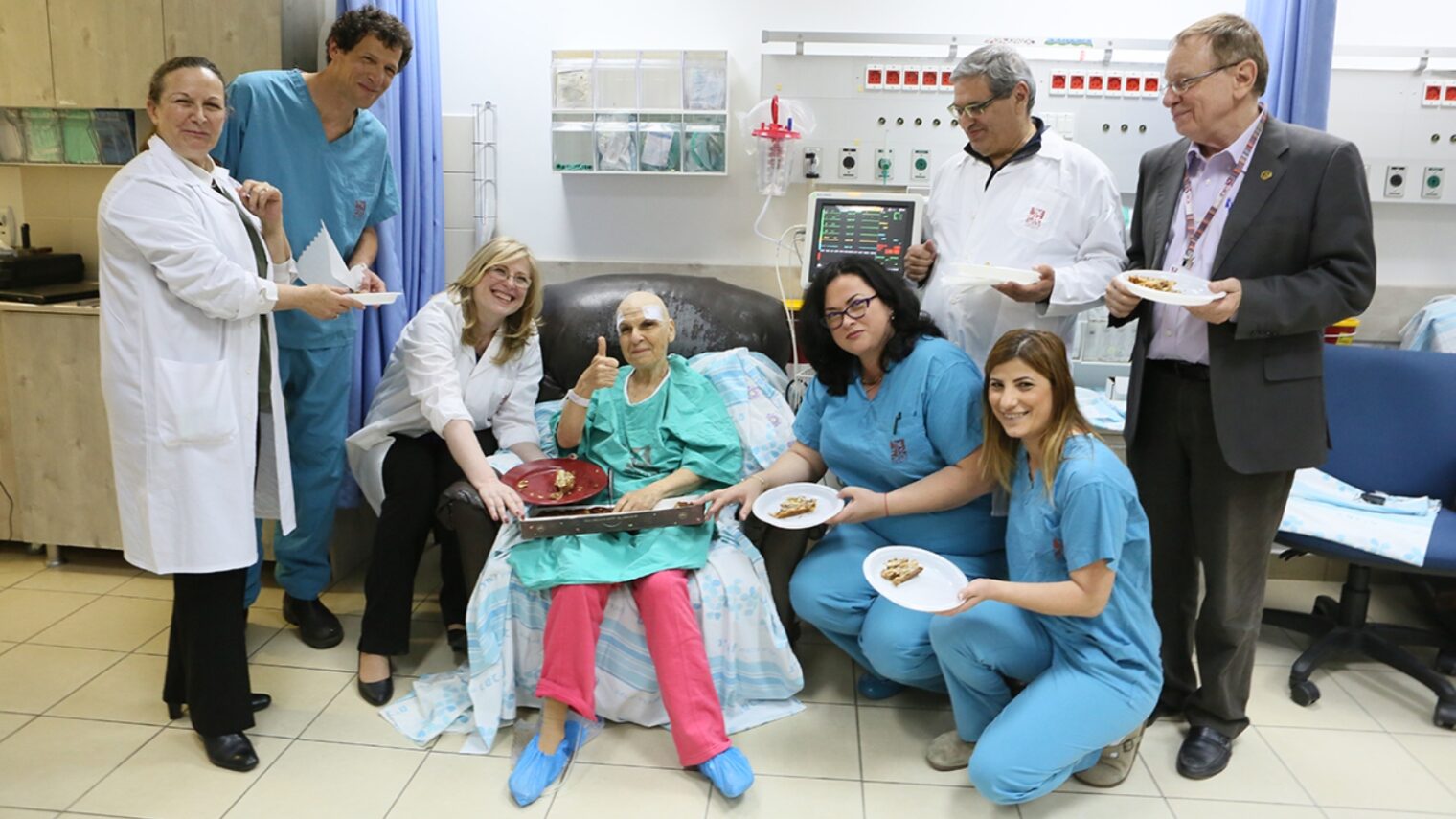 Celebrating with the patient immediately afterward her treatment with Exablate Neuro are Rambam Medical Center physicians Menashe Zaaroor, Alon Sinai, Ilana Schlesinger and Dorith Goldsher along with other support staff. Photo by Pioter Fliter/Rambam Health Care Campus