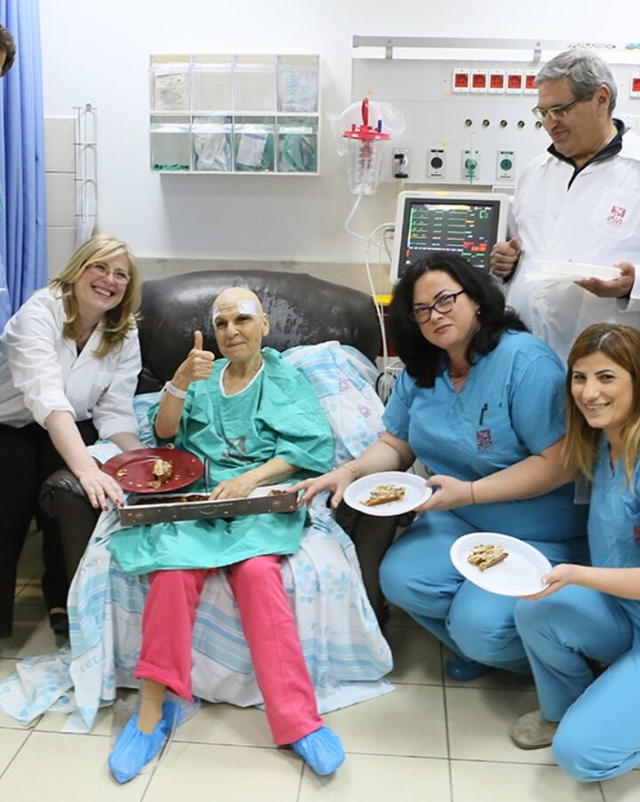 Celebrating with the patient immediately afterward her treatment with Exablate Neuro are Rambam Medical Center physicians Menashe Zaaroor, Alon Sinai, Ilana Schlesinger and Dorith Goldsher along with other support staff. Photo by Pioter Fliter/Rambam Health Care Campus
