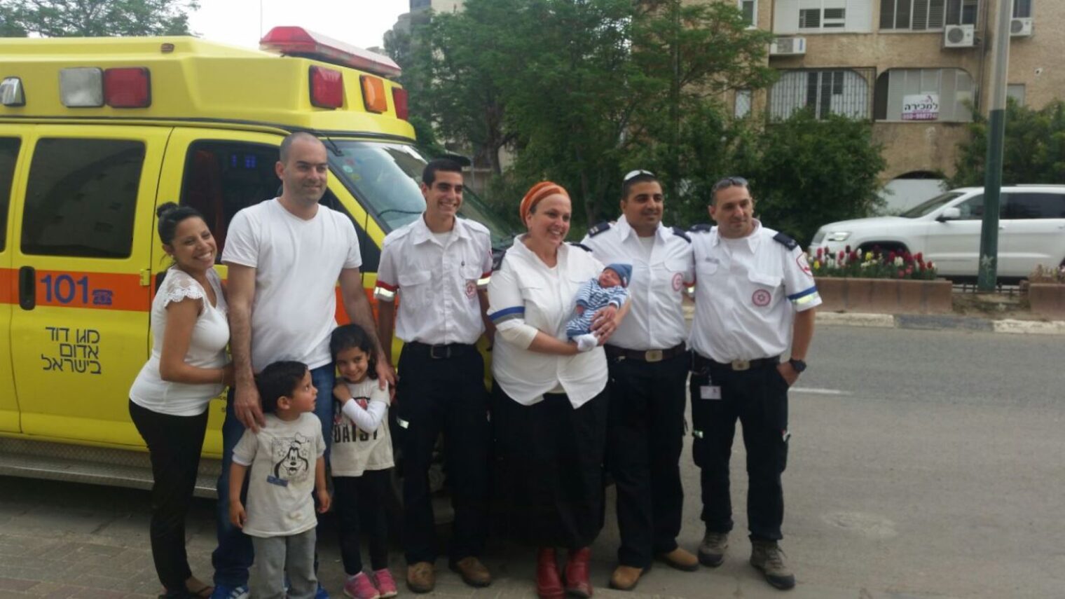From left, the Sabag family with the crew that delivered their newest addition: Adi Rachamim, Orit Ochana, Nati Liani and Yossi Akris. Photo by MDA Spokesman