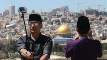 An Indonesian tourist takes a selfie in Jerusalem. Photo by Nati Shohat/FLASH90