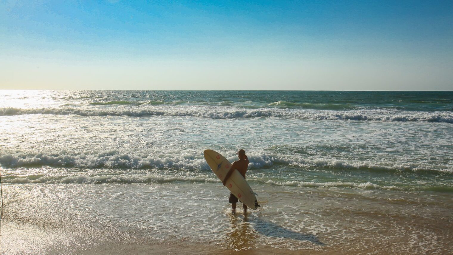 A surfer on the shore of Zikim Beach. Photo by Edi Israel/FLASH90
