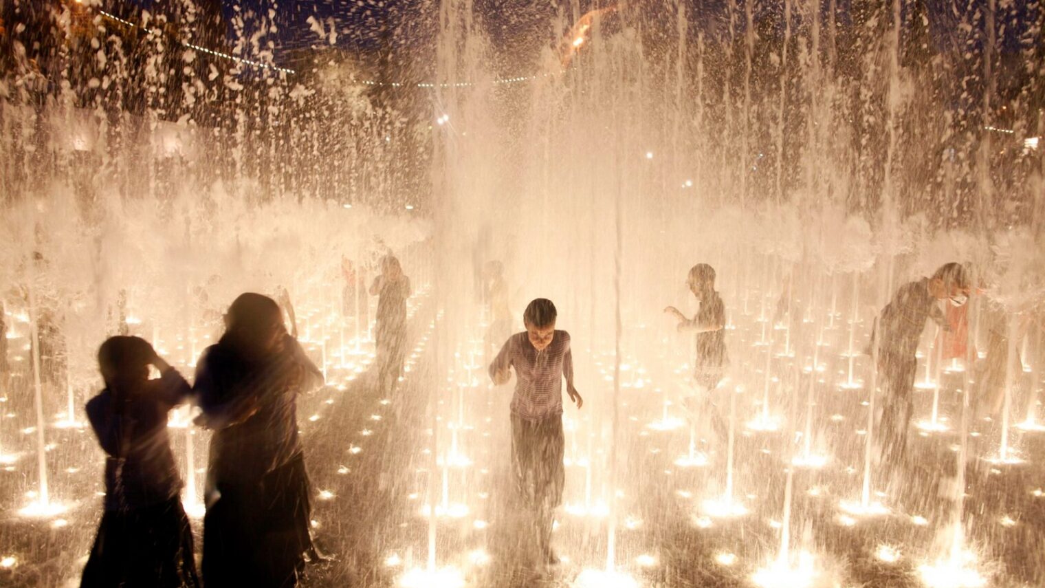 Children play in a fountain in Teddy Park opposite the Old City walls in Jerusalem. Photo by Zuzana Janku/Flash90