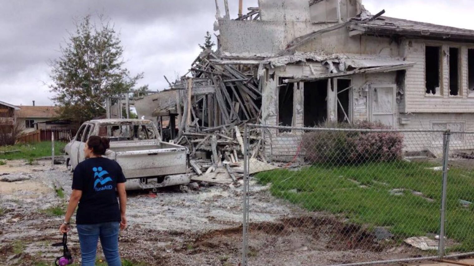 An IsraAID volunteer at the site of a burned home in Fort McMurray, Canada. Photo via Facebook