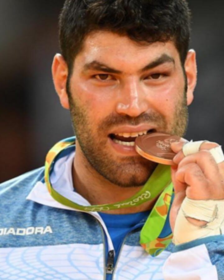 Or Sasson takes a bite out of his bronze medal at the Rio Games. Photo via instagram.com/olympicteamisrael
