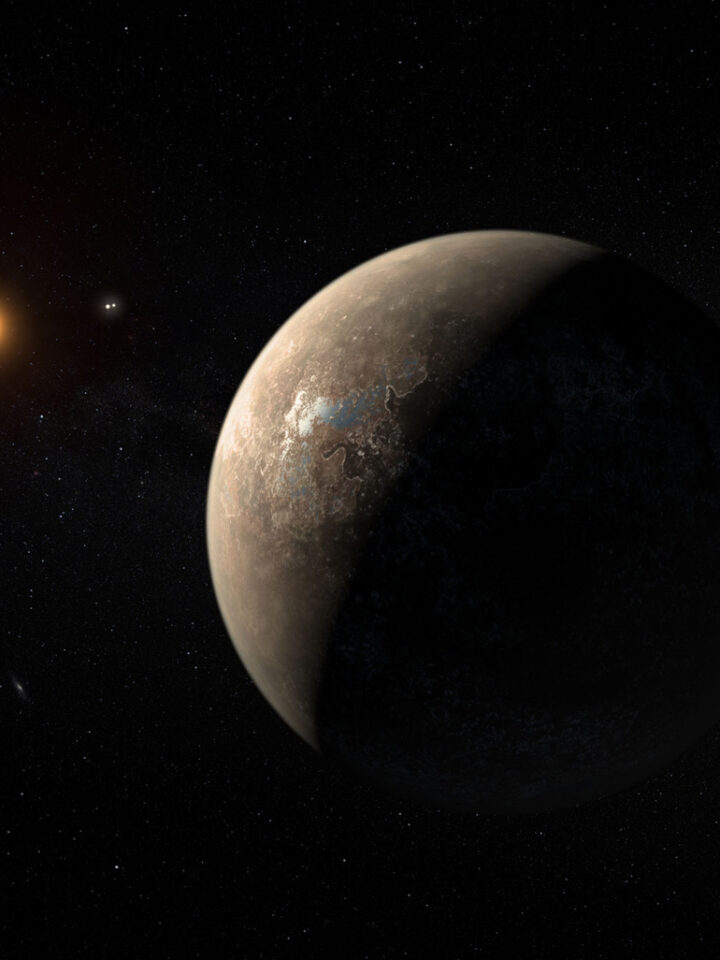 Artist’s impression shows the exoplanet Proxima b, which orbits the red dwarf star Proxima Centauri. The double star Alpha Centauri AB appears in the image between the exoplanet and its star.
Credit: ESO/M.Kornmesser