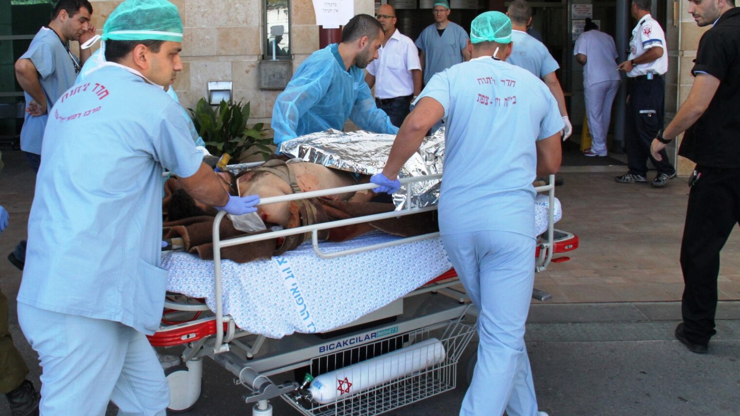 An injured civilian from the civil war in Syria being transferred to Ziv Medical Center in Israel. Photo by Simon Haddad/Ziv Medical Center