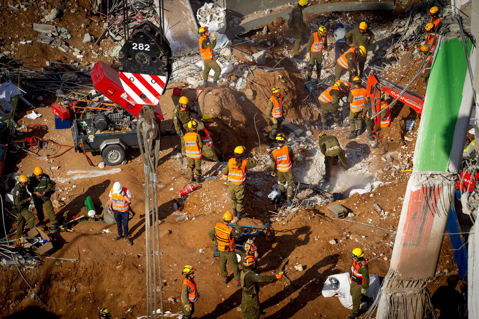 Rescue workers try to find survivors under the collapsed parking garage in Tel Aviv.  Photo by Miriam Alster FLASH90