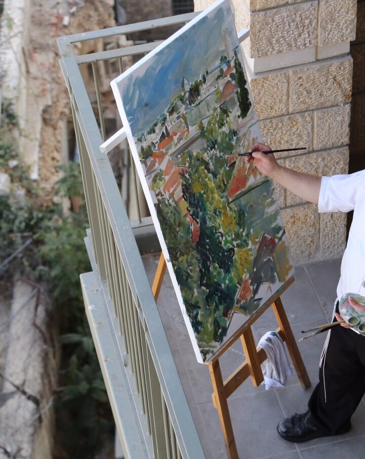 Motta Brim painting the Jerusalem skyline. Photo by Sofya Balashev