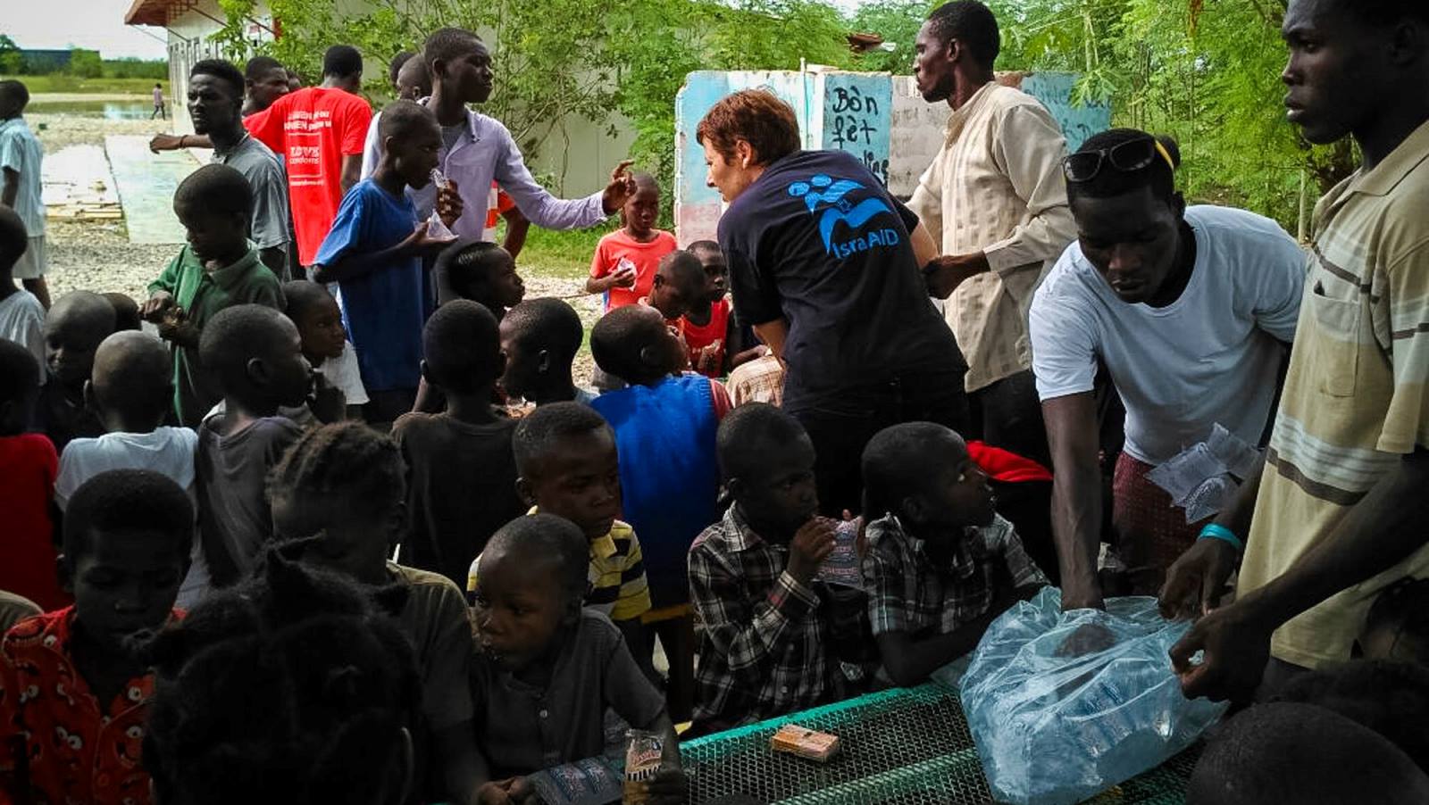 An IsraAID worker handing out necessities to Haitian children on October 7. Photo: courtesy