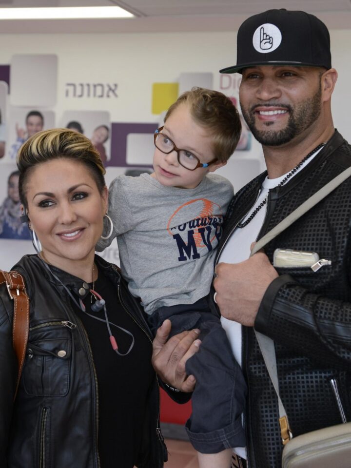 Major League Baseball's Albert Pujols and his wife Deidre hug a child at the Shalva National Children's Center in Jerusalem. Photo by Omer Burin