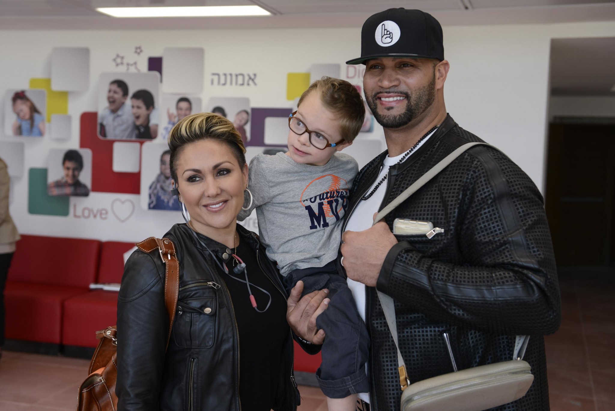 Major League Baseball's Albert Pujols and his wife Deidre hug a child at the Shalva National Children's Center in Jerusalem. Photo by Omer Burin