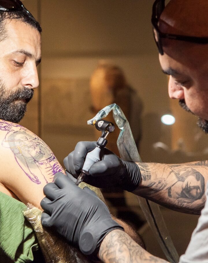 Steve Soto tattoos Barak Miron in the Archeology Wing of the Israel Museum. Photo: courtesy