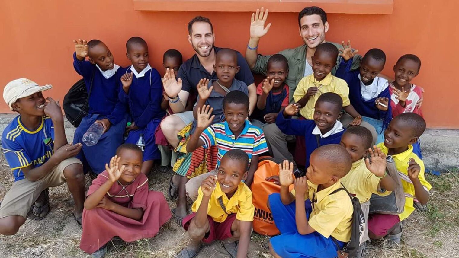 EwB TAU students Imry Atzmon, left, and Adir Shaham with schoolchildren in Minjingu, Tanzania, October 2016. Photo via Facebook