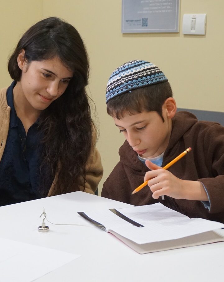 Ido trying out the adapted ruler for the first time with Hila Moore. Photo courtesy of TOM:Tikkun Olam Makers