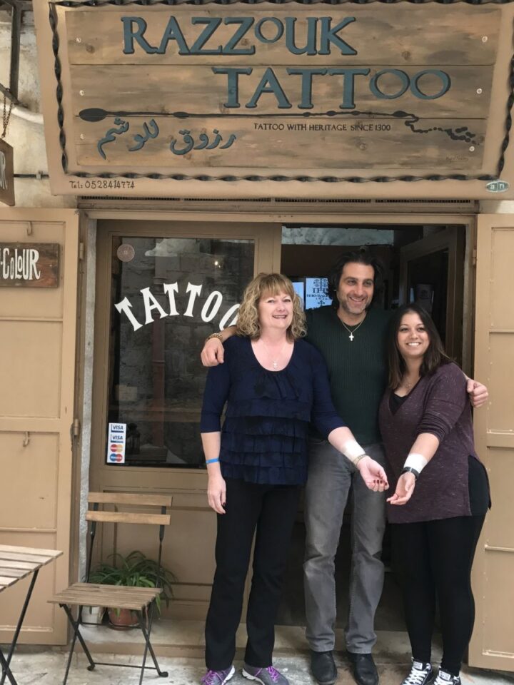 Canadian mother and daughter Debbie and Brittany with Jerusalem Old city tattoo artist Wassim Razzouk. Photo by Viva Sarah Press