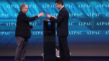 Alan Dershowitz, left, and Elliot Brandt of AIPAC drinking water from a Water-Gen unit onstage at the Policy Conference, March 26, 2017. Photo: screenshot