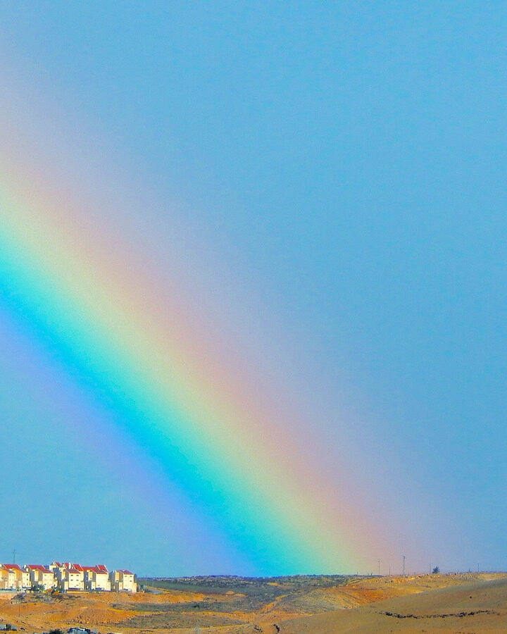Many, many rainbows. A rainbow arches over Kfar Adumim in the Judean Desert. Photo by Daniel Santacruz