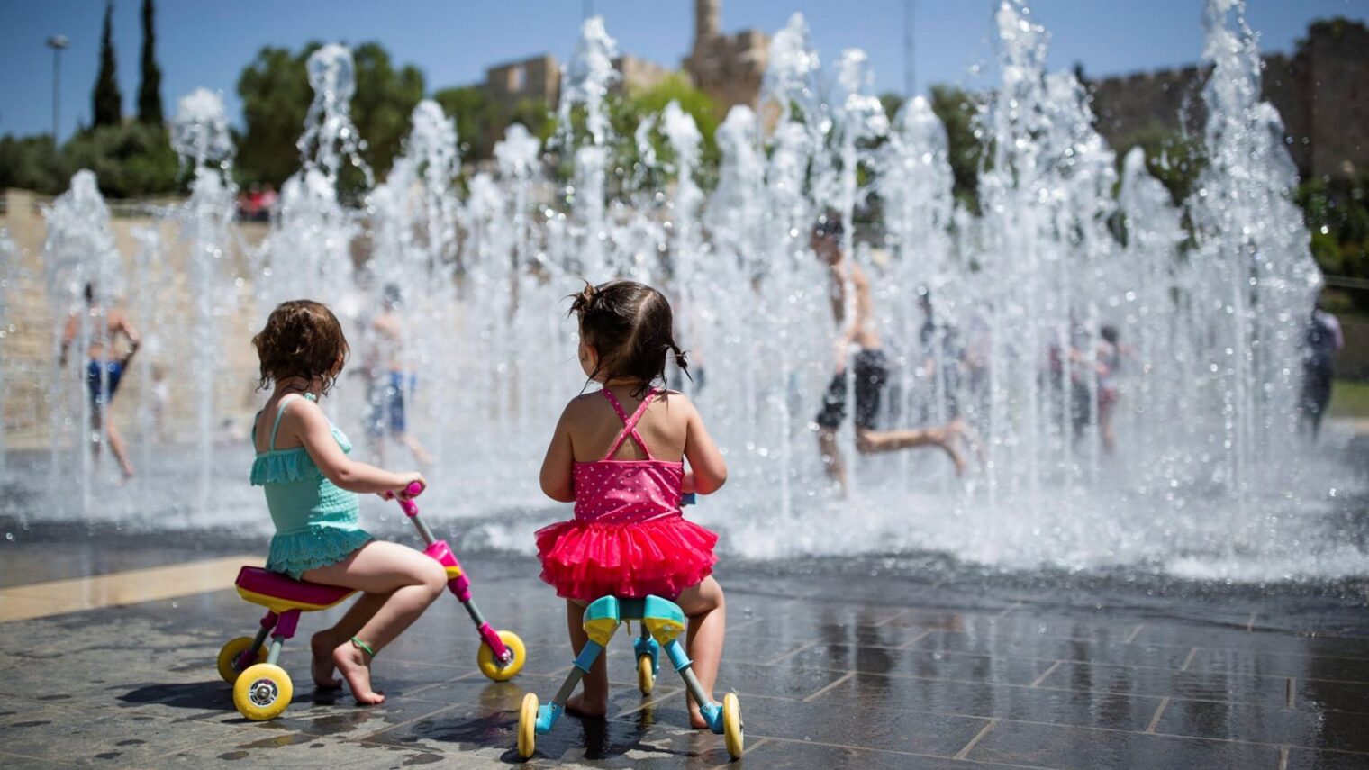 Fountains to splash in. Children play in a water fountain near the Tower of David in the Old City of Jerusalem. Photo by Corinna Kern/FLASH90