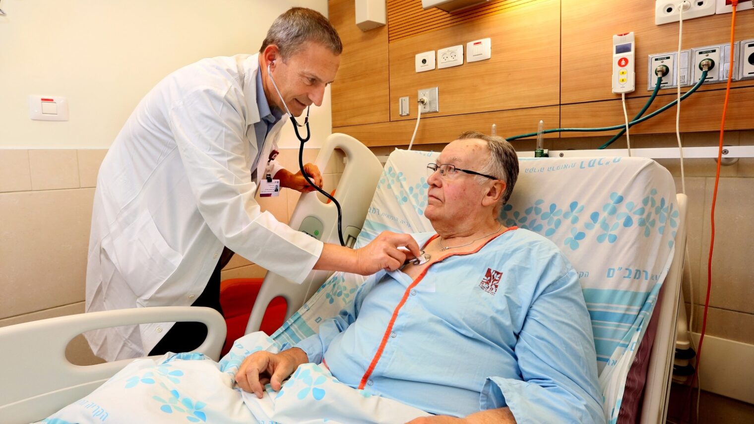Cardiologist Gil Bolotin checking patient Robert MacLachlan, the first in the world to receive the CORolla implant, at Rambam Health Care Campus, Haifa. Photo by Pioter Fliter/RHCC