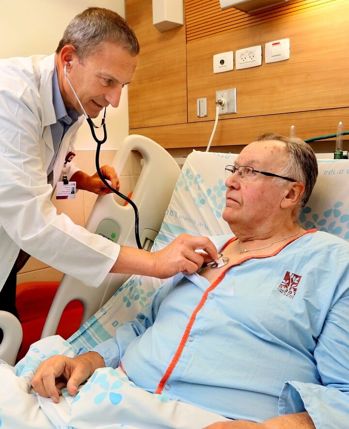 Cardiologist Gil Bolotin checking patient Robert MacLachlan, the first in the world to receive the CORolla implant, at Rambam Health Care Campus, Haifa. Photo by Pioter Fliter/RHCC
